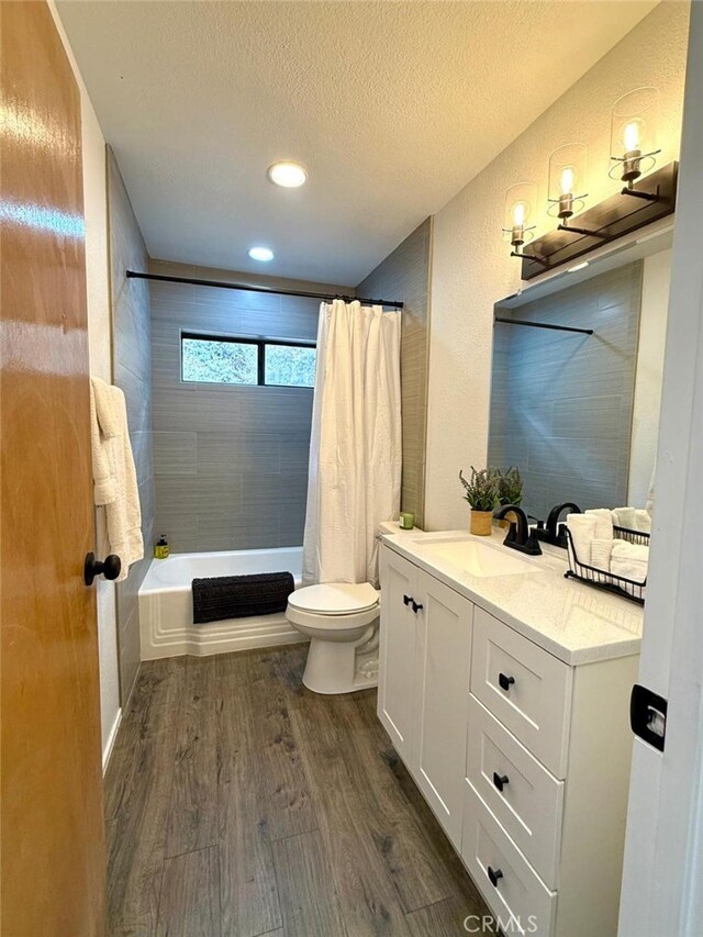 1909 Pioneer Way, Pine Mountain Club, CA 93222 - bathroom with wood finished floors, vanity, shower / bathtub combination with curtain, a textured ceiling, and recessed lighting