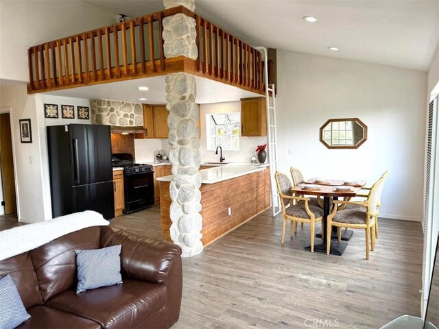 1909 Pioneer Way, Pine Mountain Club, CA 93222 - kitchen with black appliances, light countertops, brown cabinets, backsplash, and wood finished floors