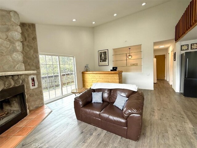 1909 Pioneer Way, Pine Mountain Club, CA 93222 - living area with a towering ceiling, wood finished floors, a fireplace, and recessed lighting