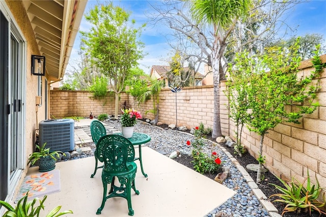 view of patio featuring central AC unit and a fenced backyard