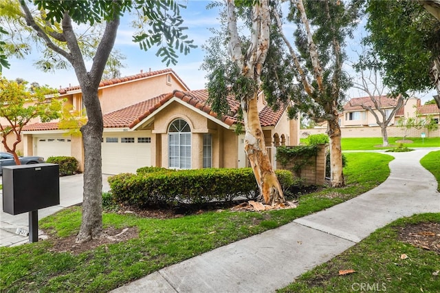 mediterranean / spanish-style home featuring a tiled roof, an attached garage, concrete driveway, and stucco siding