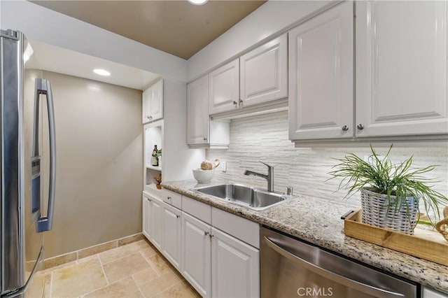 1200 E Ocean Blvd Unit 59, Long Beach, CA 90802 - kitchen featuring stainless steel appliances, a sink, baseboards, stone tile floors, and white cabinets