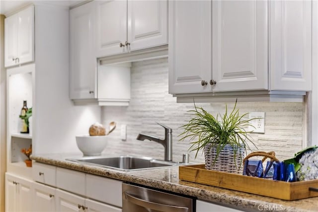1200 E Ocean Blvd Unit 59, Long Beach, CA 90802 - kitchen with stainless steel dishwasher, tasteful backsplash, white cabinetry, a sink, and light stone countertops