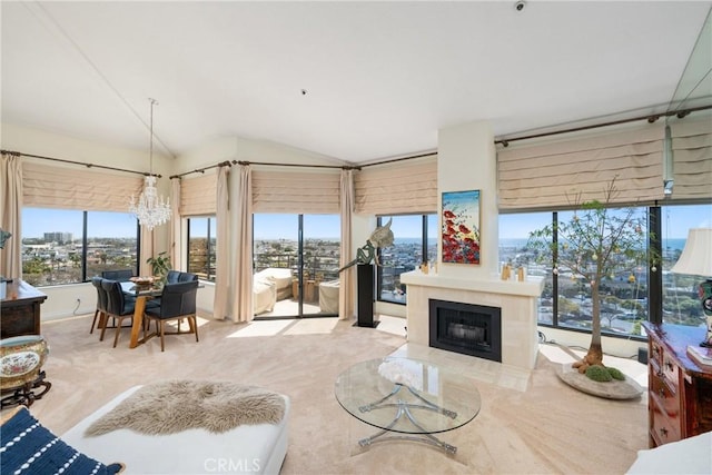 210 Lille Ln Unit 313, Newport Beach, CA 92663 - carpeted living area with lofted ceiling, a fireplace, and a chandelier