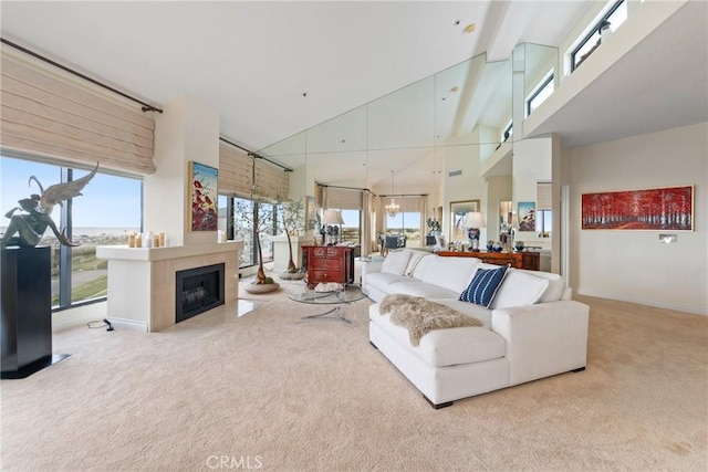 210 Lille Ln Unit 313, Newport Beach, CA 92663 - carpeted living area featuring baseboards, a wealth of natural light, a glass covered fireplace, and high vaulted ceiling