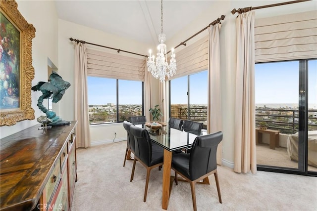 210 Lille Ln Unit 313, Newport Beach, CA 92663 - dining room with baseboards, lofted ceiling, an inviting chandelier, and light colored carpet
