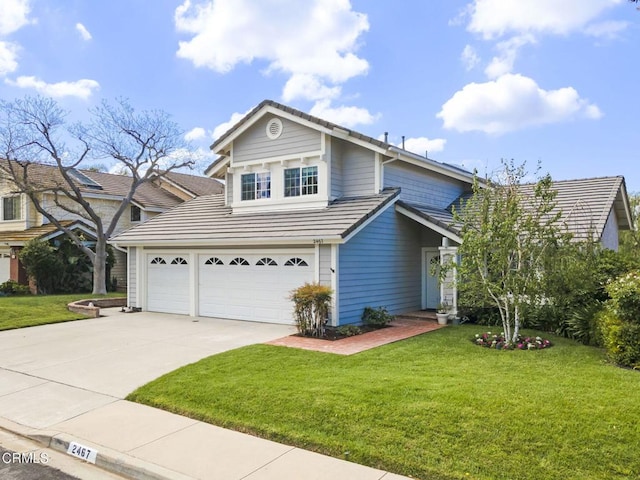 traditional-style home featuring a tiled roof, an attached garage, driveway, and a front yard