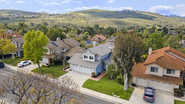 drone / aerial view featuring a residential view and a mountain view