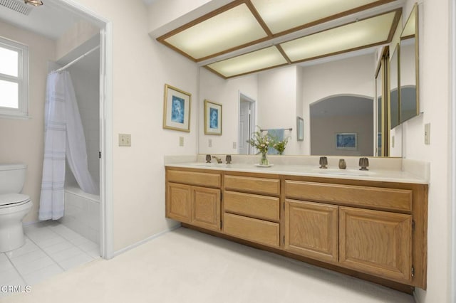 bathroom with double vanity, toilet, visible vents, and a sink