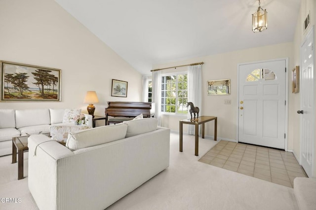 carpeted living area with baseboards, visible vents, and lofted ceiling