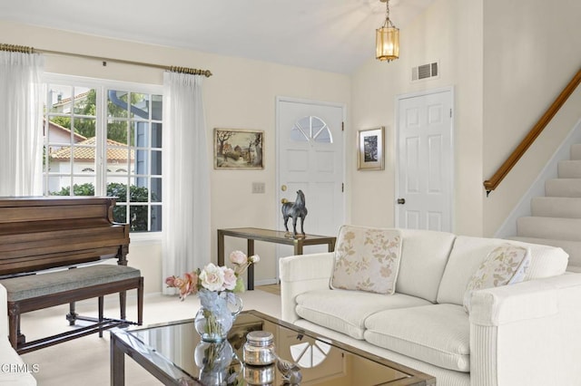 living area featuring stairs and visible vents