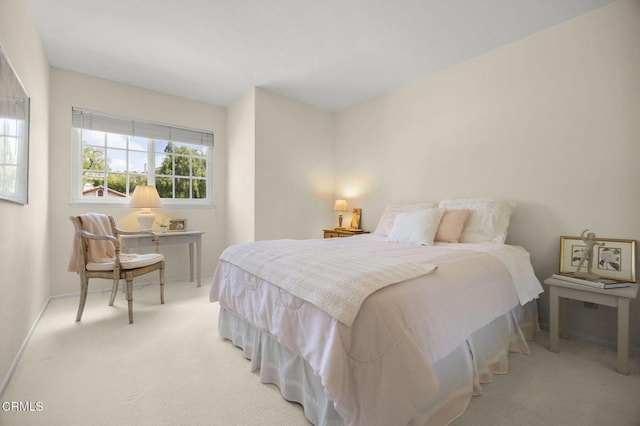 carpeted bedroom featuring baseboards