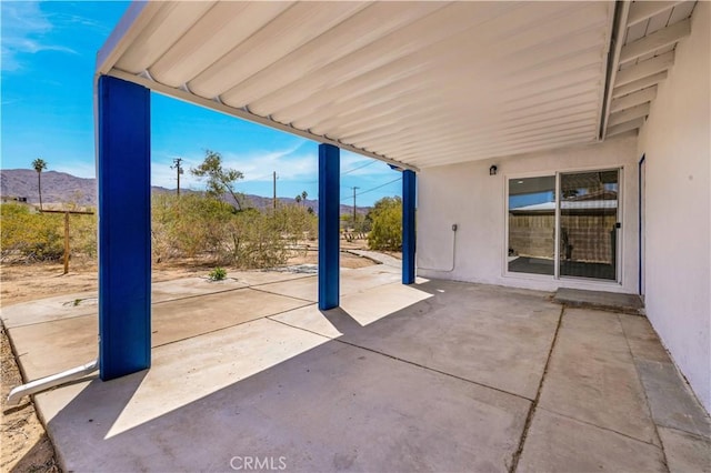view of patio / terrace with a mountain view and an attached carport