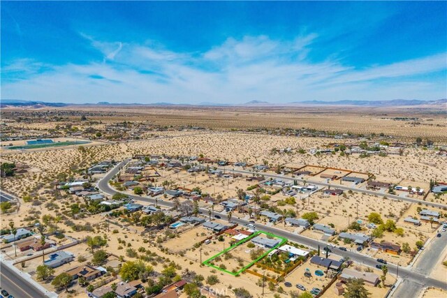 birds eye view of property featuring a mountain view, view of desert, and a rural view