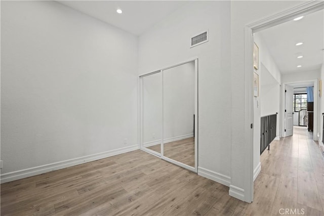 unfurnished bedroom featuring recessed lighting, baseboards, visible vents, and wood finished floors