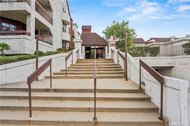 exterior space with fence and stairs