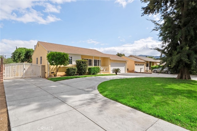 ranch-style house featuring an attached garage, stucco siding, a front yard, a gate, and driveway