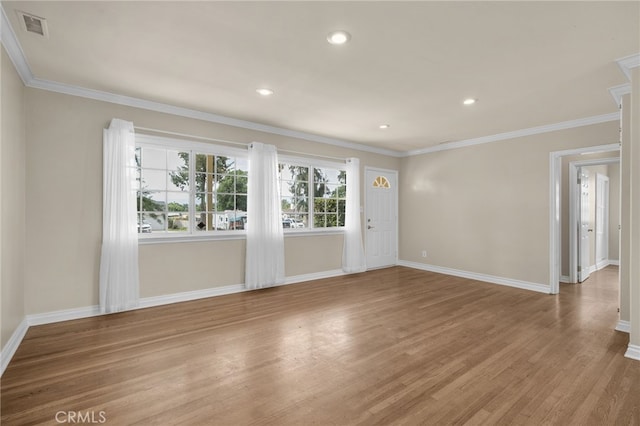 unfurnished living room featuring light wood-type flooring, ornamental molding, and baseboards