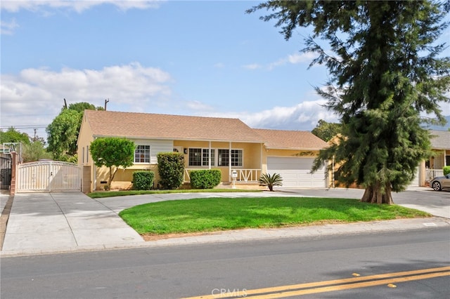 single story home featuring a garage, a front yard, stucco siding, a gate, and concrete driveway