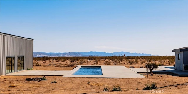60810 Cole Ln, Landers, CA 92285 - view of storm shelter featuring a mountain view, a desert view, a patio, and a rural view