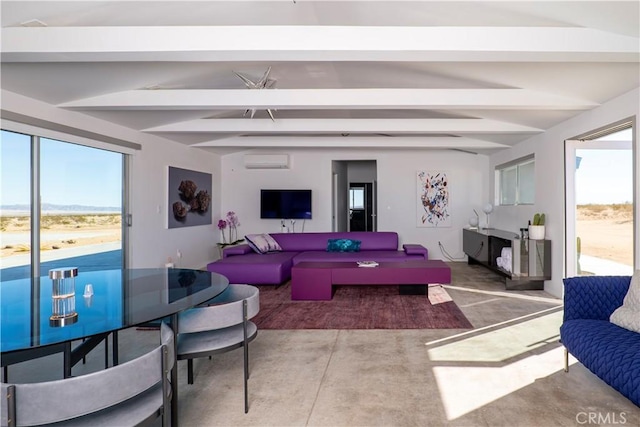 60810 Cole Ln, Landers, CA 92285 - living area with beam ceiling, a healthy amount of sunlight, and a wall mounted air conditioner