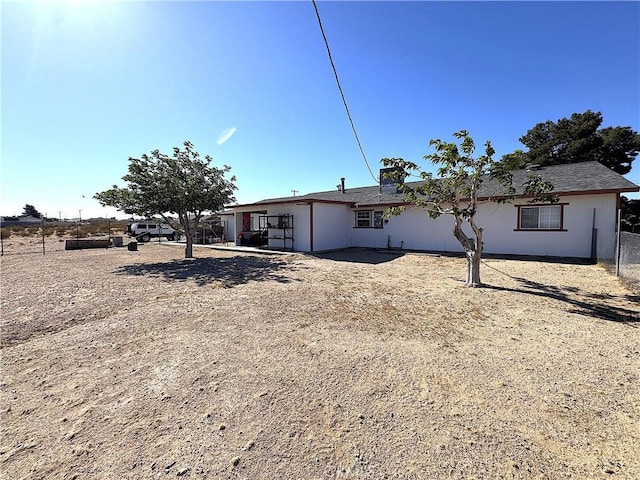 rear view of property featuring fence