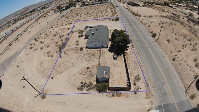 birds eye view of property with a mountain view and a desert view
