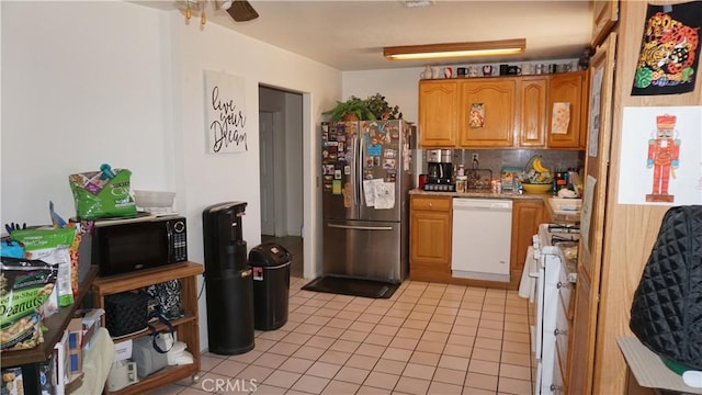 kitchen with ceiling fan, white appliances, light countertops, light tile patterned floors, and backsplash