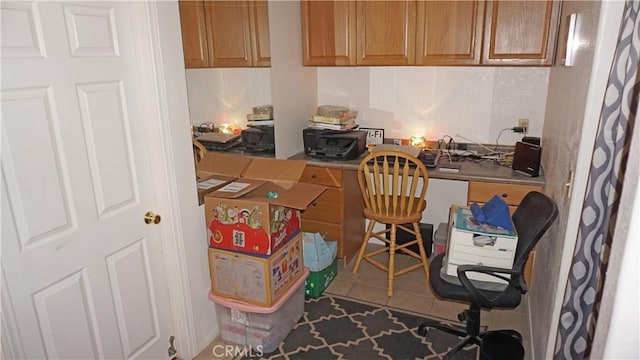 office area featuring tile patterned floors and built in desk