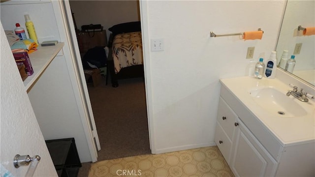 bathroom featuring tile patterned floors, baseboards, and vanity