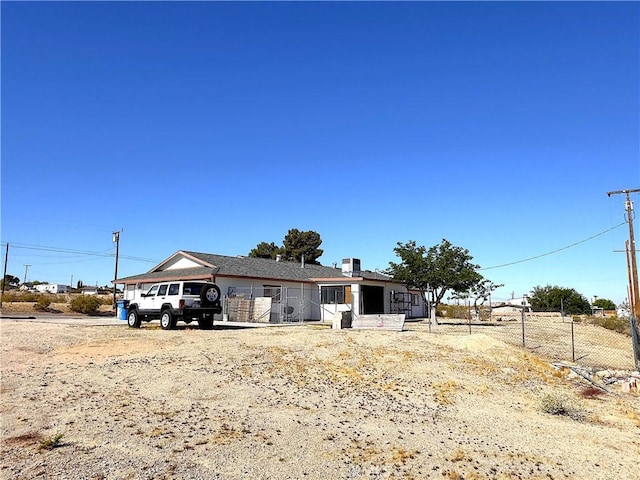 view of front of home featuring fence