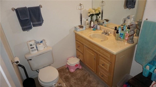 bathroom with toilet and vanity