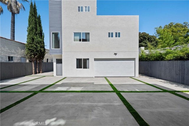 2937 W Blvd, Los Angeles, CA 90016 - back of house with fence, an attached garage, driveway, and stucco siding