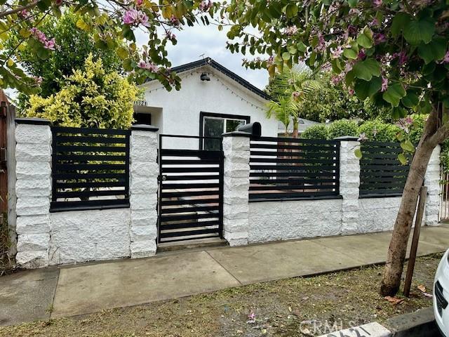 view of gate with a fenced front yard