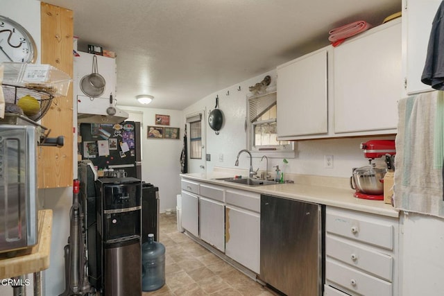 kitchen with light countertops, stainless steel appliances, and a sink