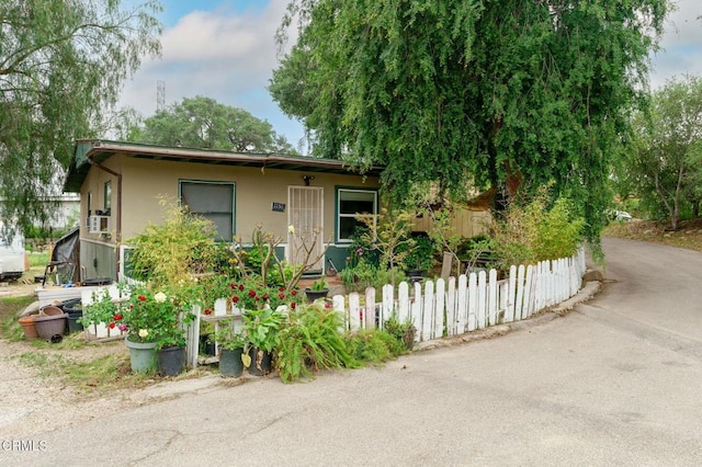 view of front of property featuring fence and stucco siding