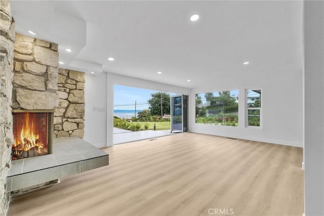 43 Rockinghorse Rd, Rancho Palos Verdes, CA 90275 - unfurnished living room with wood finished floors, recessed lighting, and a stone fireplace