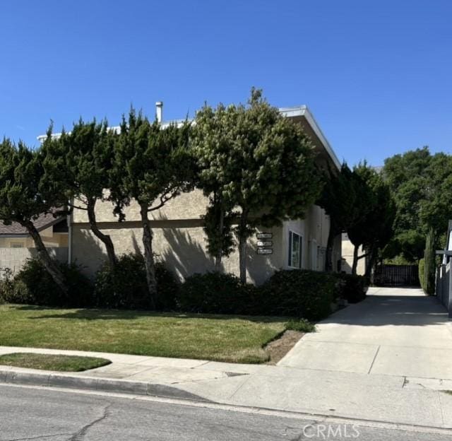 view of home's exterior featuring fence and a yard