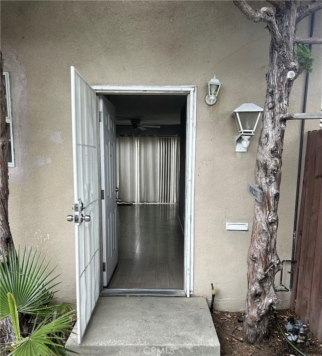 entrance to property with stucco siding