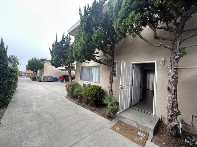 entrance to property featuring stucco siding