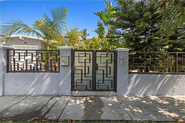 view of gate featuring a fenced front yard