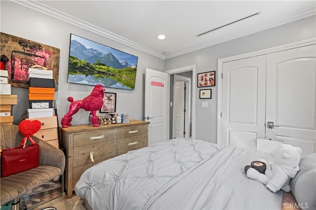 bedroom featuring a closet, ornamental molding, and recessed lighting