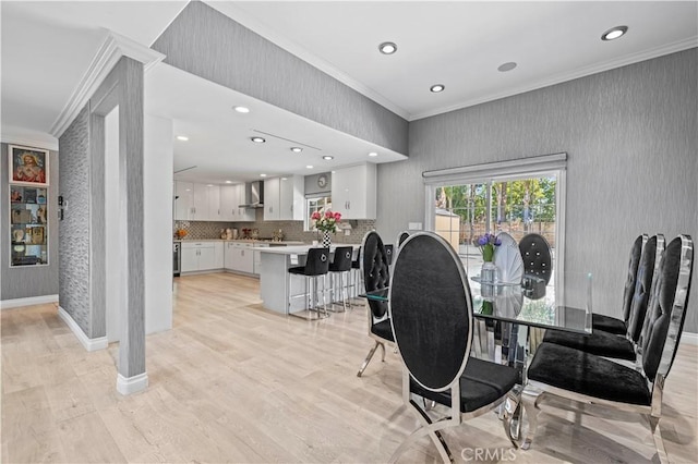 dining space with light wood-type flooring, baseboards, wallpapered walls, ornamental molding, and recessed lighting
