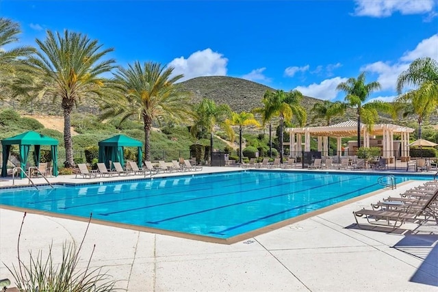 28345 Hearthside Dr, Menifee, CA 92584 - community pool with a mountain view, fence, and a patio area