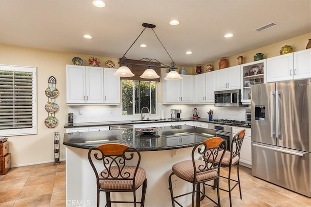 28345 Hearthside Dr, Menifee, CA 92584 - kitchen featuring appliances with stainless steel finishes, white cabinetry, recessed lighting, a sink, and a center island