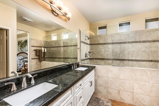 28345 Hearthside Dr, Menifee, CA 92584 - full bathroom featuring walk in shower, double vanity, and tile walls