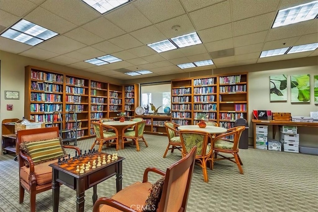 28345 Hearthside Dr, Menifee, CA 92584 - living area featuring carpet flooring, bookshelves, and a drop ceiling