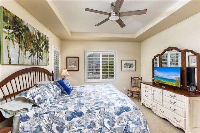 28345 Hearthside Dr, Menifee, CA 92584 - bedroom featuring a tray ceiling, light colored carpet, and ceiling fan