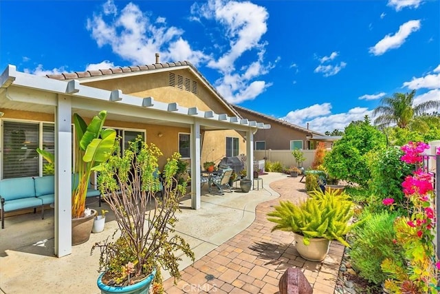 28345 Hearthside Dr, Menifee, CA 92584 - back of property with a patio, fence, stucco siding, and an outdoor living space