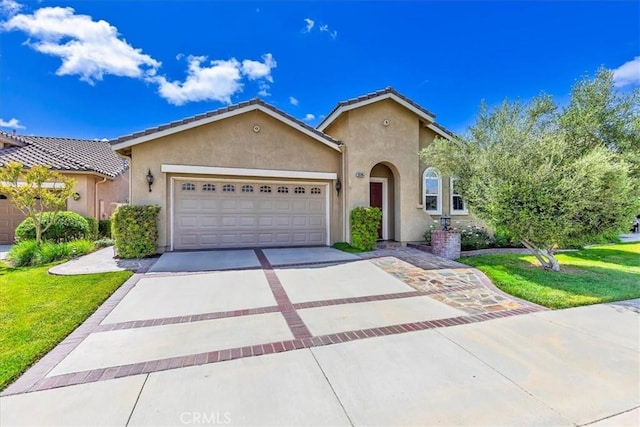 28345 Hearthside Dr, Menifee, CA 92584 - mediterranean / spanish house featuring stucco siding, concrete driveway, an attached garage, and a front yard